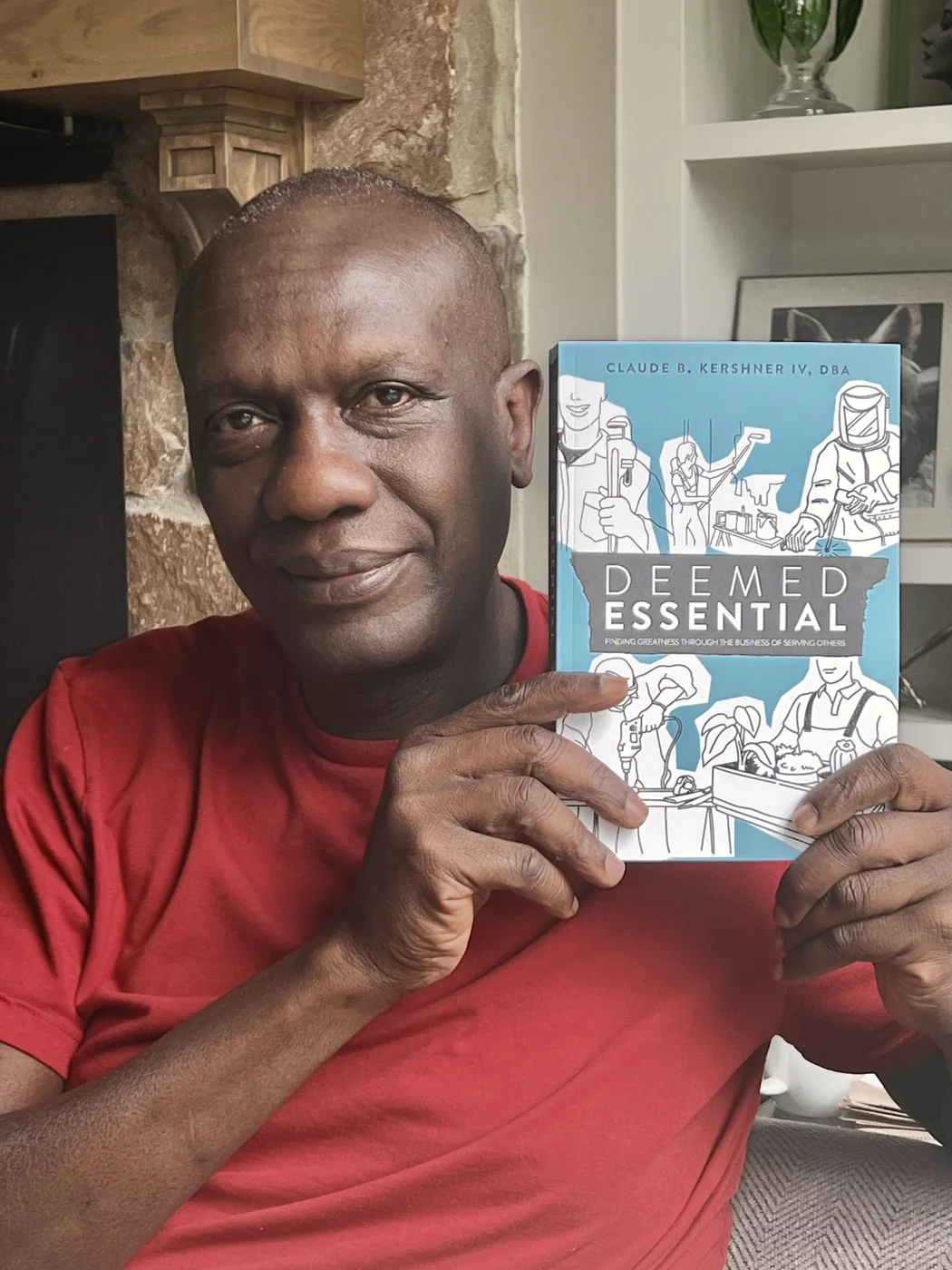 A reader holding a copy of Deemed Essential